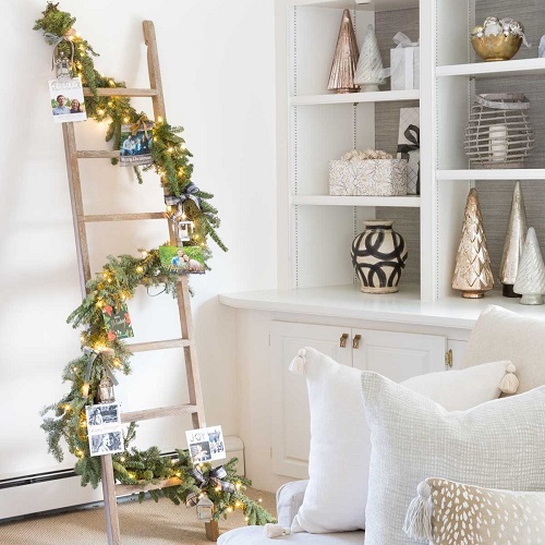 Blanket Ladder with Photographs, String Lights, and Evergreen Garland