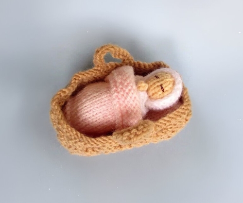 Swaddled Baby in a Basket Crib